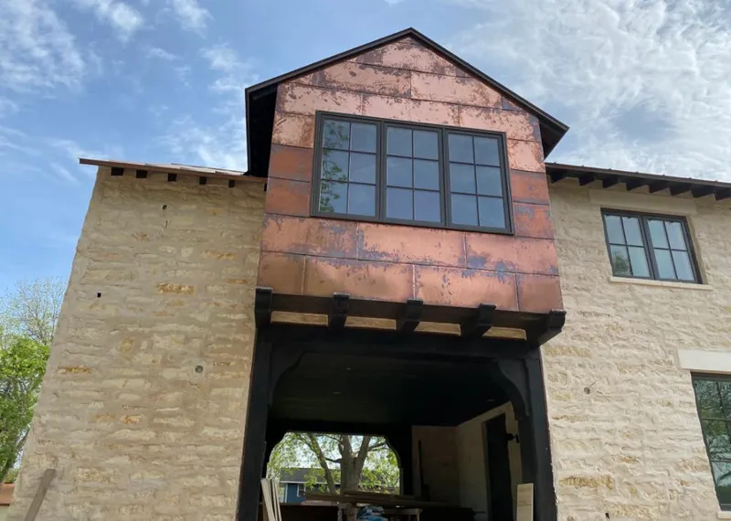 Copper metal panel facade on a stone building for Skylight Installation in Palmetto