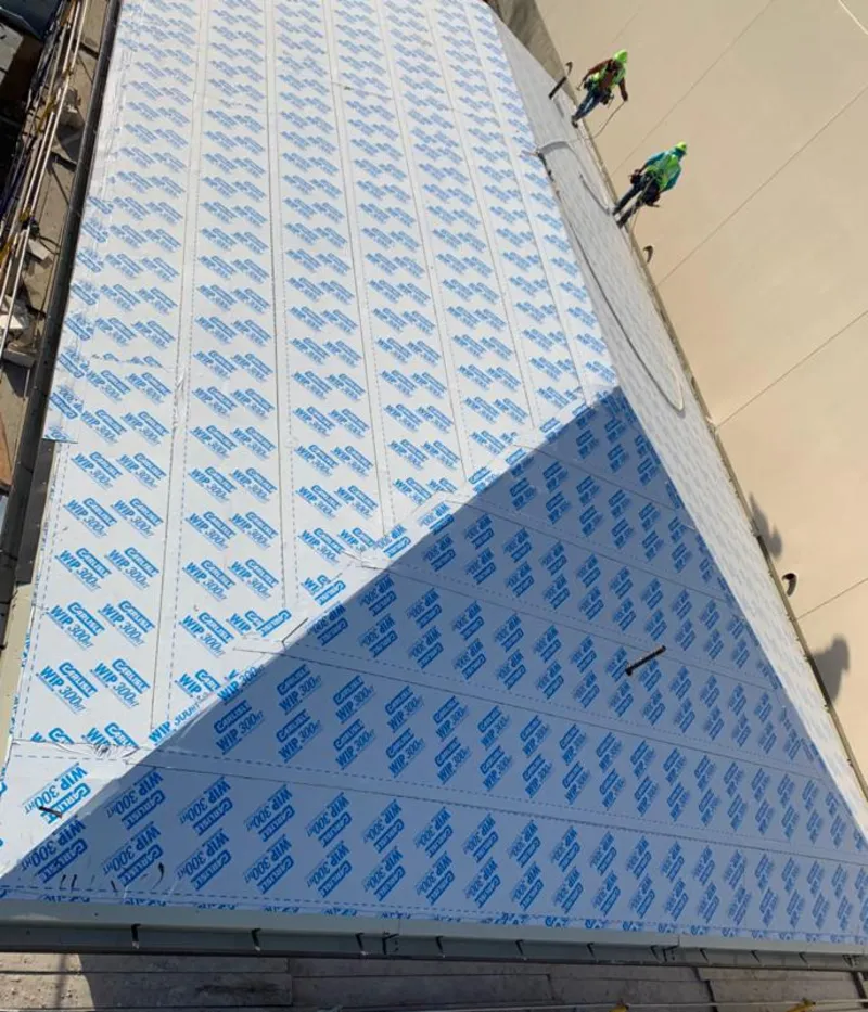 Professional roofers installing underlayment on a metal roof in Palmetto